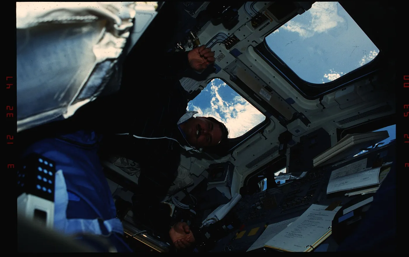S35 11 032 STS 35 MS Hoffman changes a roll of film on 's aft flight deck DPLA 4e490ed1aaec534361dc79b5fd4ee8d6