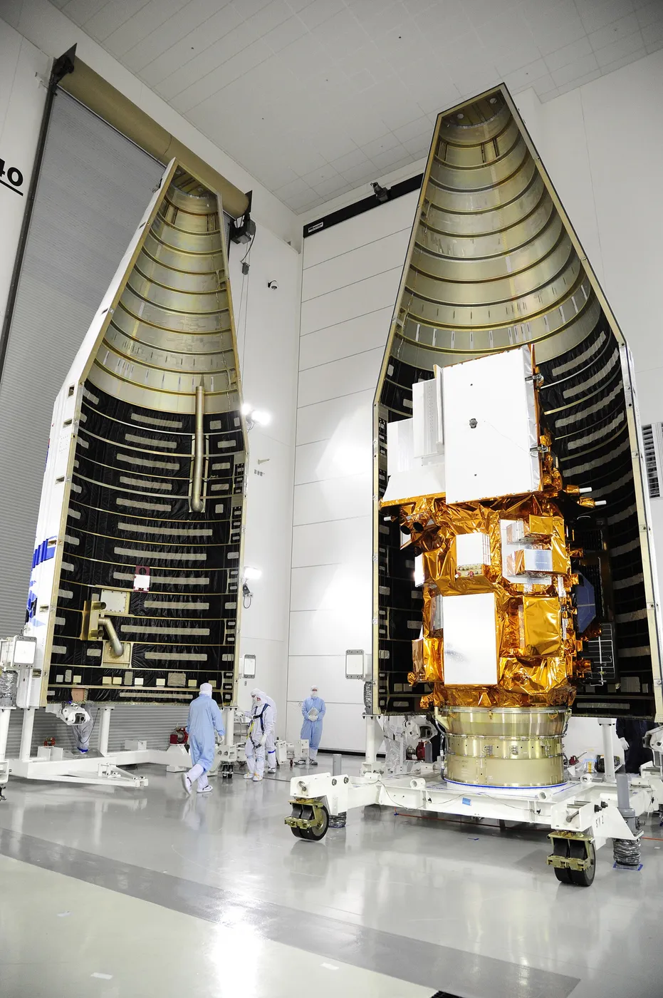 Technicians encapsulate the NASA's LDCM satellite in its payload fairing.
