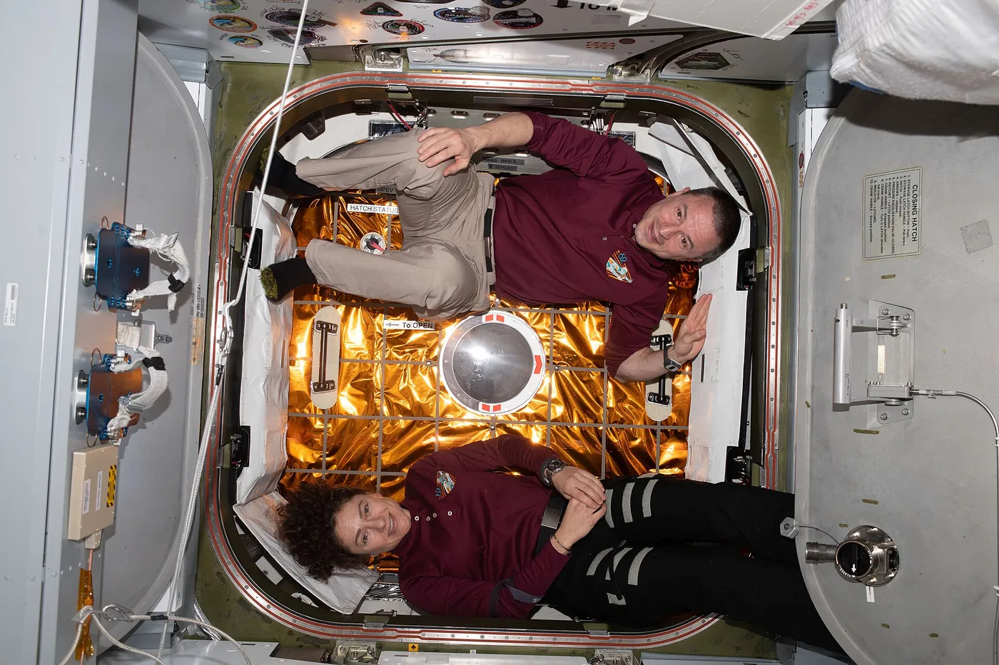 Expedition 62 Flight Engineers Jessica Meir and Andrew Morgan are pictured in front of the hatch to the Space Dragon resupply ship shortly after it…