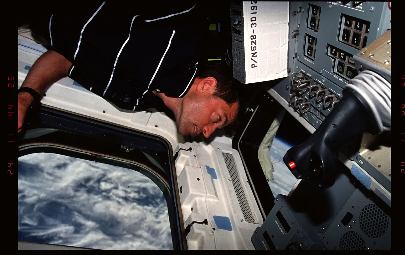 301 017 Pilot Ashby looks at the Earth through the windows on the aft flight deck DPLA 0d2d8b4430b1c65dacde5120bbef660e