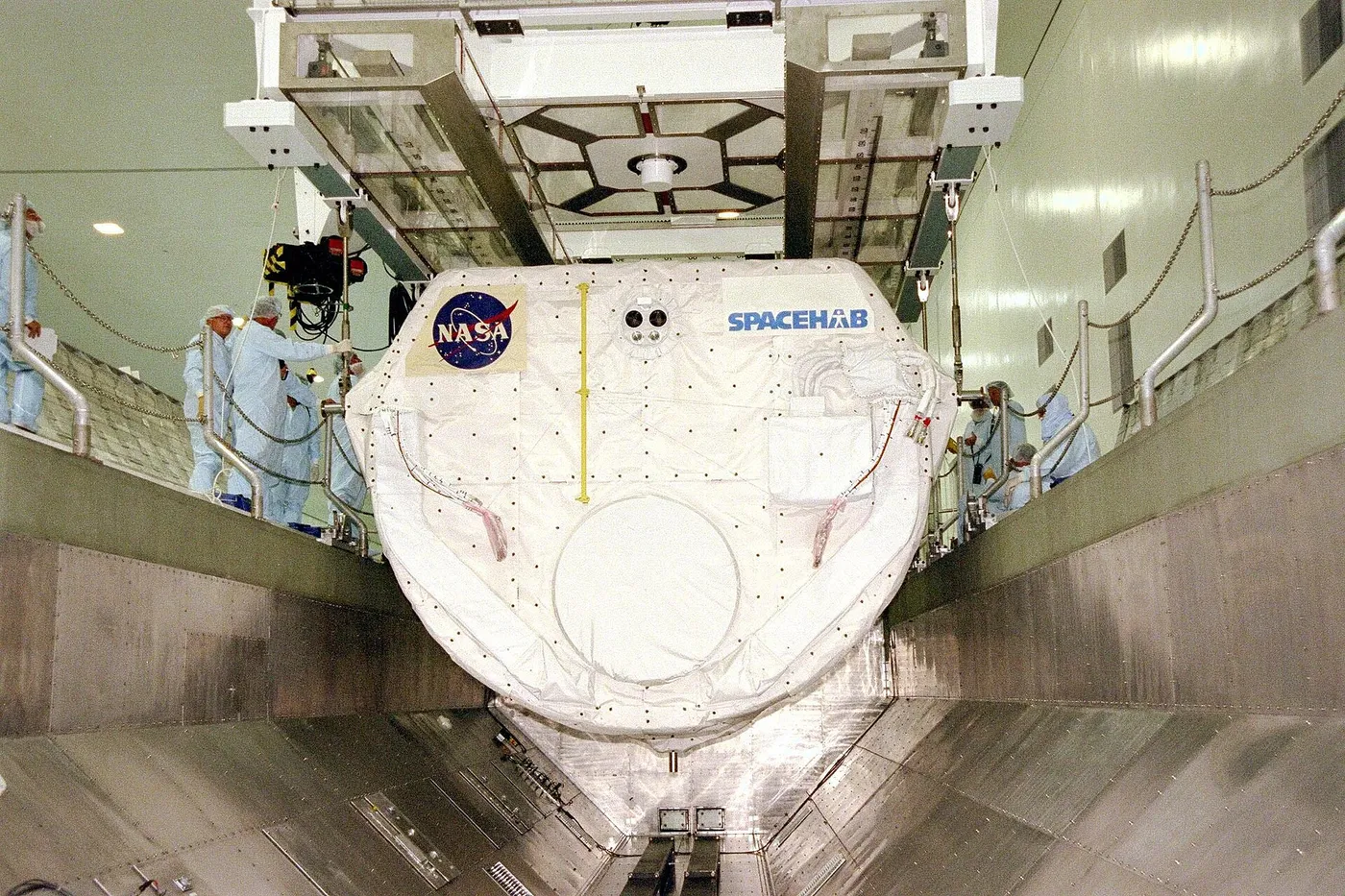 Spacehab Single Module lowered into Shuttle payload canister prior to STS 91
