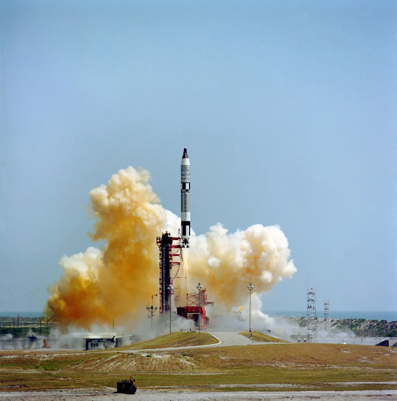 The launch seen across the complex, the Titan trailing smoke over the Florida scrub.