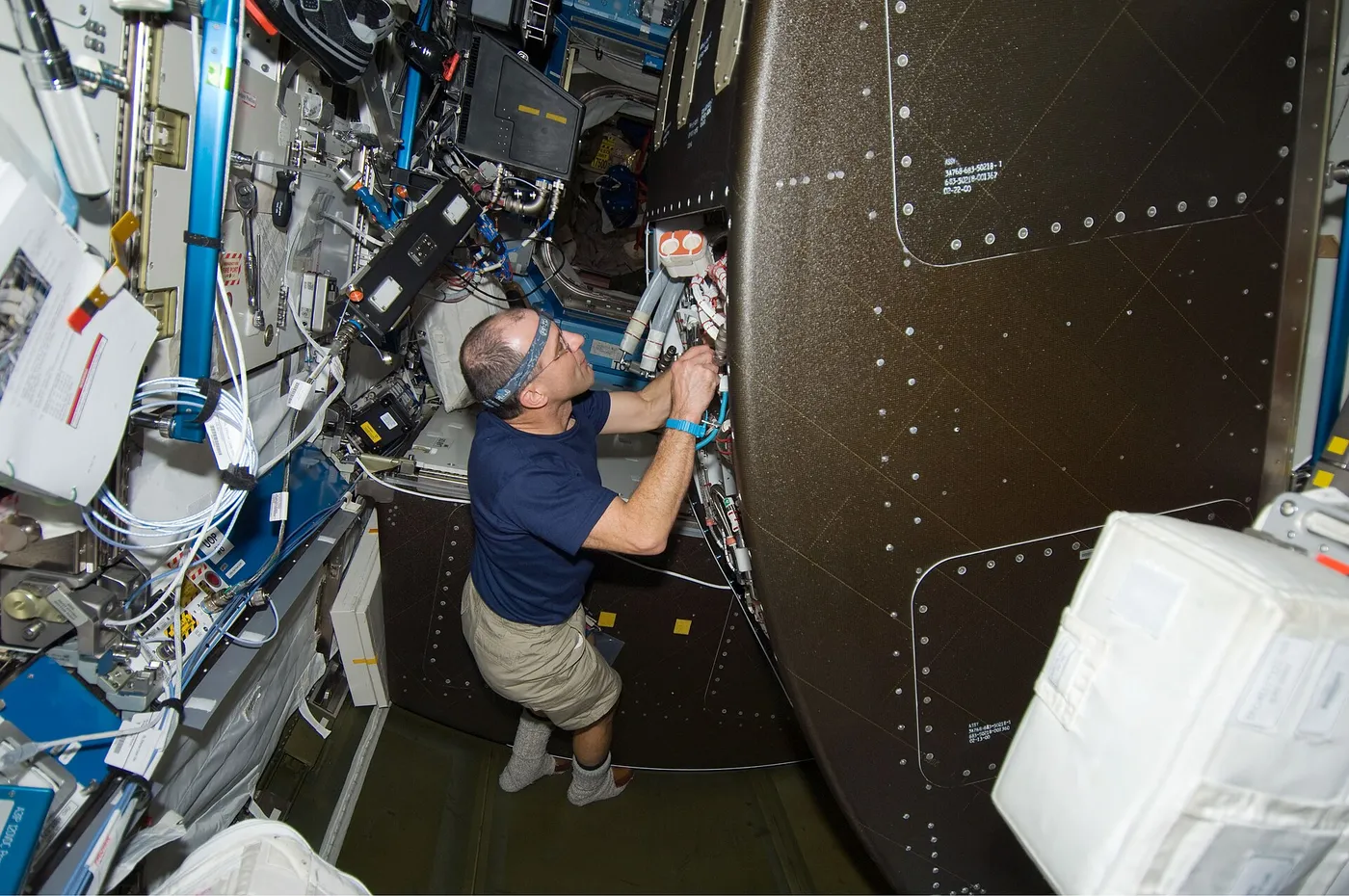 Astronaut Donald Pettit, STS-126 mission specialist, configures the Water Recovery System (WRS) rack in the Destiny laboratory of the International…