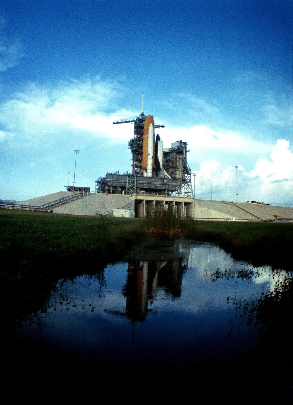 The space shuttle orbiter Challenger (STS-8) and its launch vehicle arrive at Pad 39A after a 3 1/2-mile trip from the Vehicle Assembly Building. the…