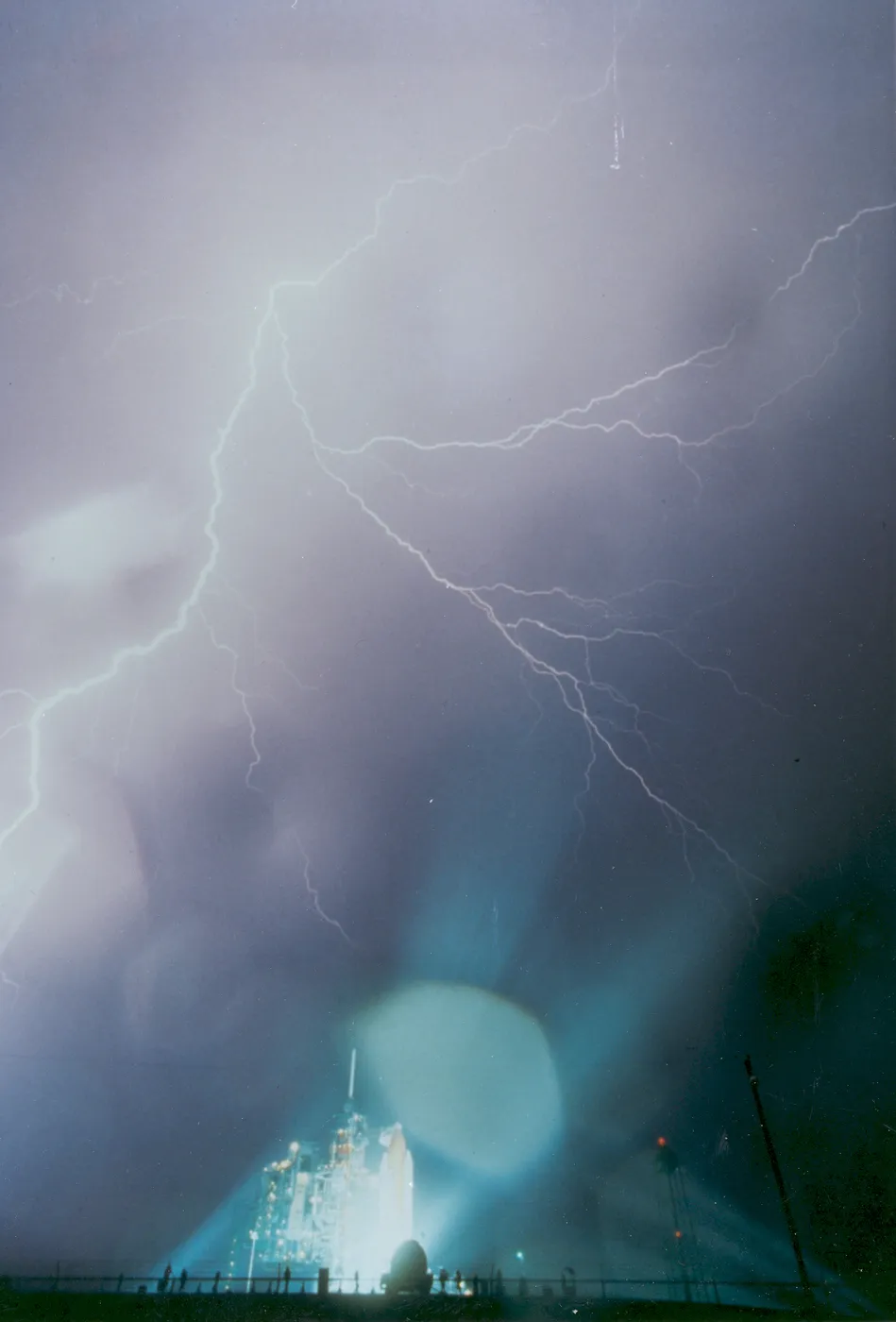 Spectacular lightning bolts streak through the rainy skies in the early morning before the STS-8 launch at Kennedy Space Center.