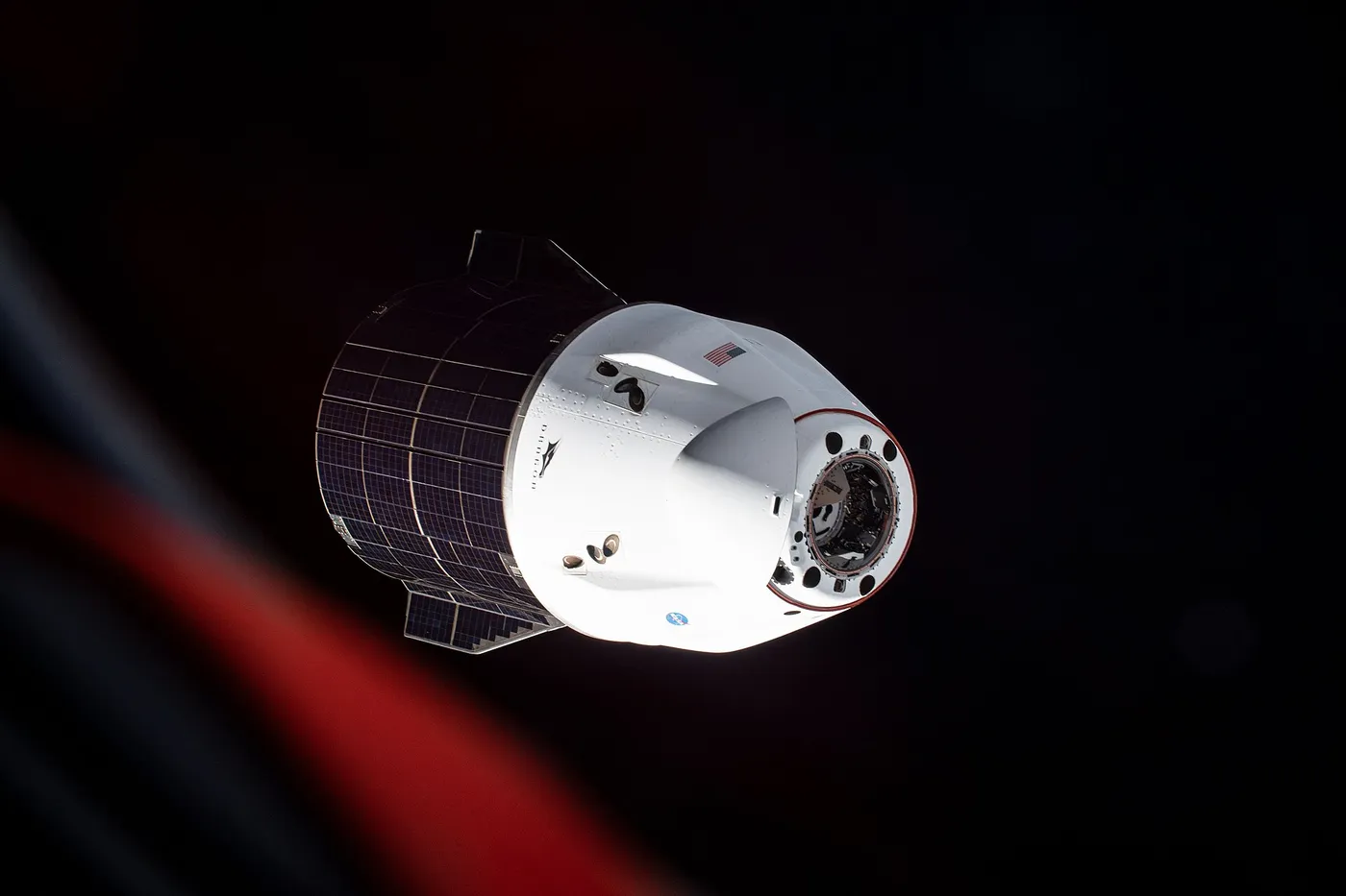 iss065e162284 (July 8, 2021) --- The SpaceX Cargo Dragon resupply ship is photographed departing the International Space Station after it undocked…