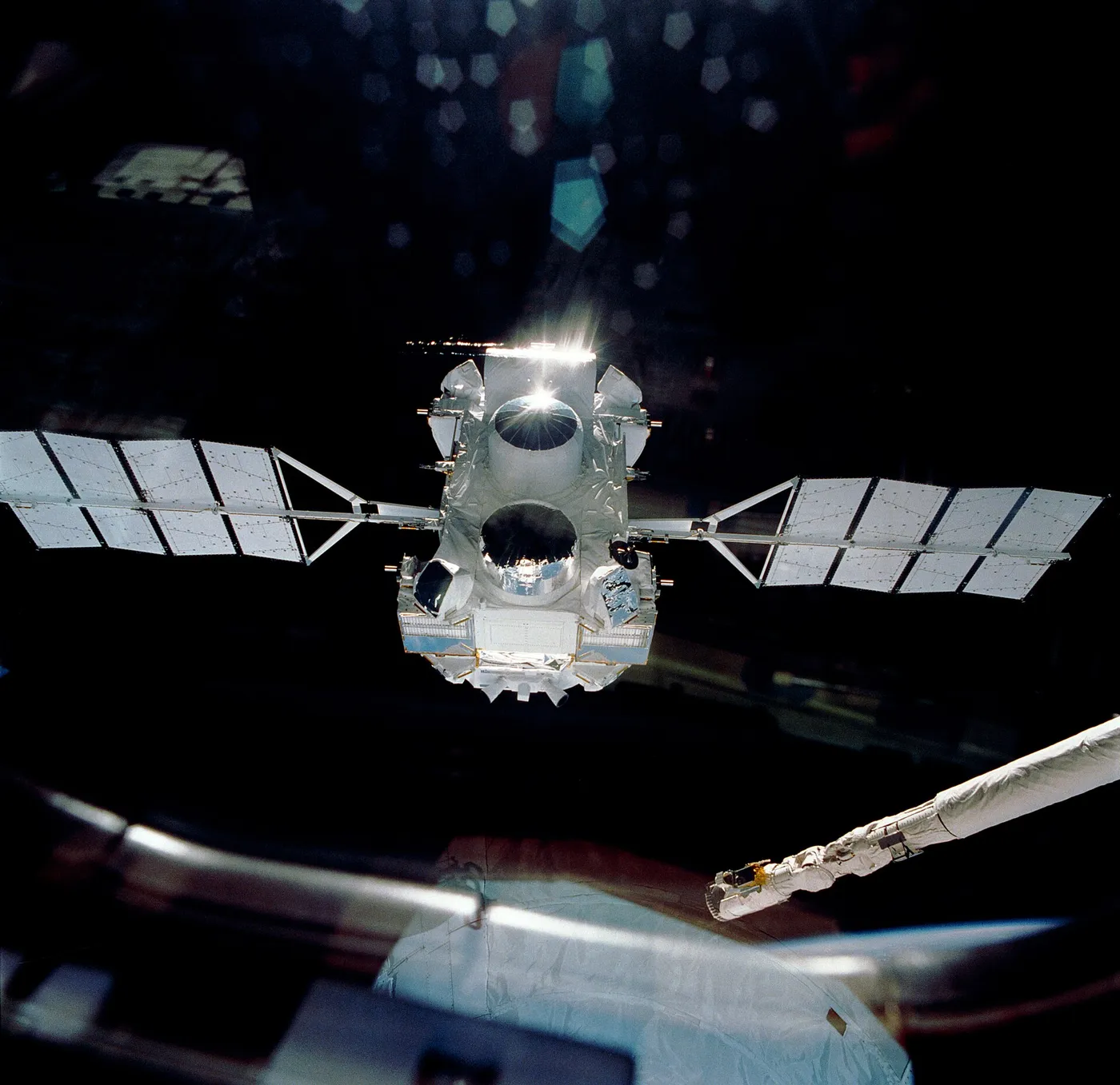 NASA's Compton Gamma Ray Observatory drifts away from the space shuttle Atlantis on April 7, 1991, following its deployment during the STS-37 mission.