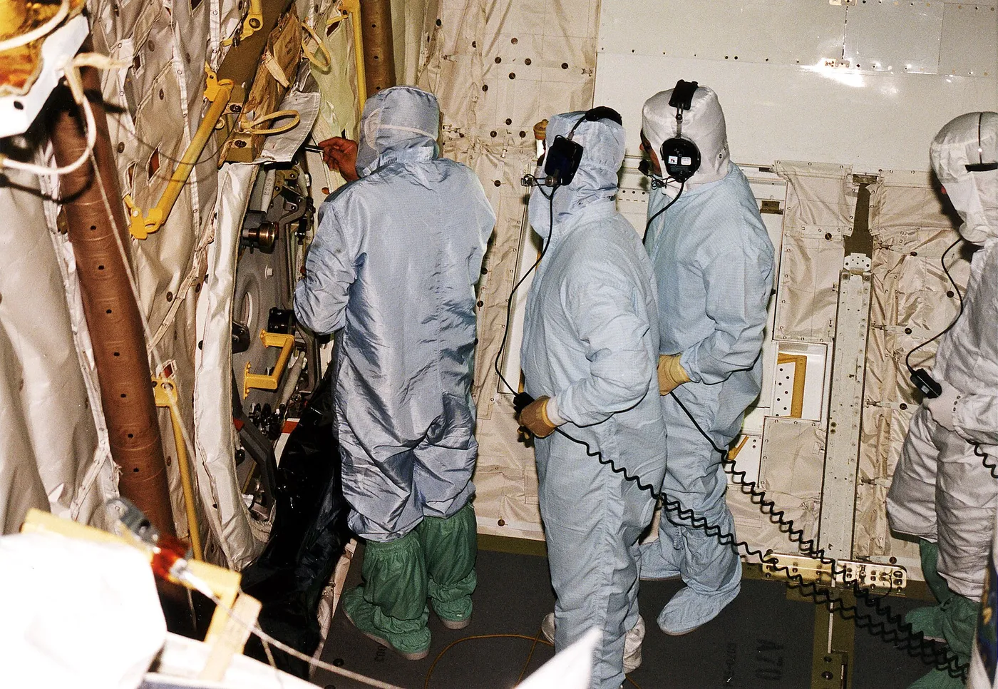 United Space Alliance (USA) technicians in Orbiter Processing Facility Bay 1 troubleshoot the orbiter Columbia's outer hatch of the airlock, which…