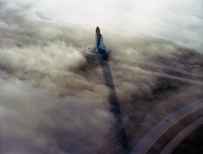 (November 30, 1982) The Space Shuttle Challenger rolls out to Pad 39A in the morning fog in this picture taken before the STS-6 mission began. This…