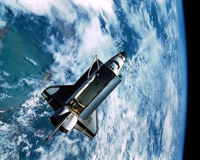 The space shuttle orbiter Discovery seen from the IMAX camera aboard the SPAS-ORFEUS satellite during mission STS-51 in September 1993.