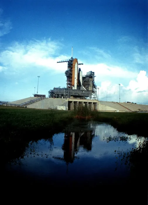 The space shuttle orbiter Challenger (STS-8) and its launch vehicle arrive at Pad 39A after a 3 1/2-mile trip from the Vehicle Assembly Building. the…