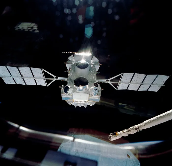NASA's Compton Gamma Ray Observatory drifts away from the space shuttle Atlantis on April 7, 1991, following its deployment during the STS-37 mission.