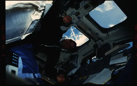 S35 11 032 STS 35 MS Hoffman changes a roll of film on 's aft flight deck DPLA 4e490ed1aaec534361dc79b5fd4ee8d6