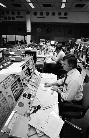 Mission Control Center (MCC) activities during Day-1 of the STS-9 mission with Flight Director Jay H. Greene and Lt. Gen. James A. Abrahamson. 1. Lt.…