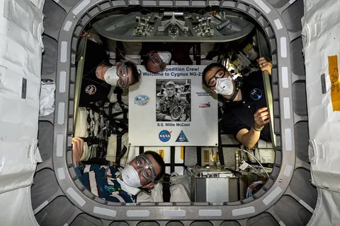 Expedition 73 astronauts pictured inside the Cygnus XL cargo craft