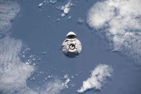 The SpaceX Dragon cargo craft approaches the space station