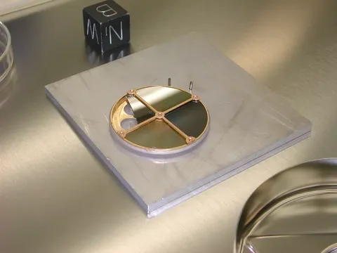 Concentrator Target Being Disassembled at JSC Prior to Long-Term Nitrogen Storage Post-Return