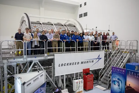 NASA KSC employees and astronauts pose for a group photo while standing on the platform rig of the Lunar Orbital Platform-Gateway space station…