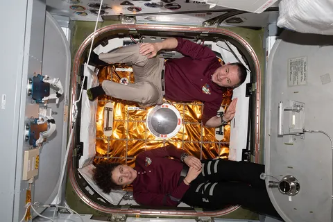 Expedition 62 Flight Engineers Jessica Meir and Andrew Morgan are pictured in front of the hatch to the Space Dragon resupply ship shortly after it…