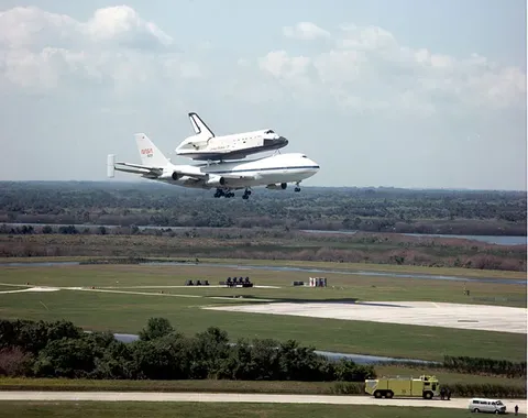 NASA space shuttle orbiter Challenger, riding on the 747/shuttle carrier aircraft, returns to Kennedy Space Center after landing at Edwards Air Force…