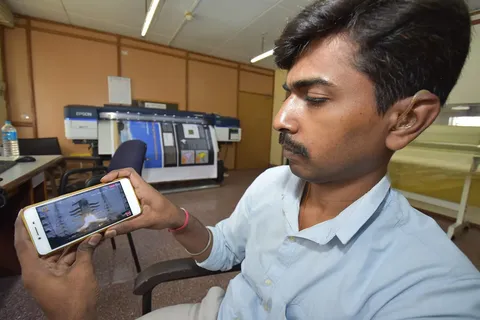 Siddhesh DC, an office employee observes live chandrayaan 2 launching on his mobile in Kolkata, India.