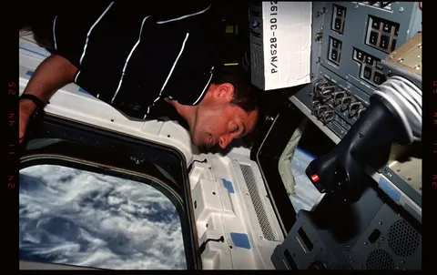 301 017 Pilot Ashby looks at the Earth through the windows on the aft flight deck DPLA 0d2d8b4430b1c65dacde5120bbef660e