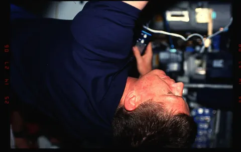 03 011 Crewmember in the middeck setting up the Heat Pipe Performance experiment. DPLA 04ce20487032b2f6578bfc083d558a49
