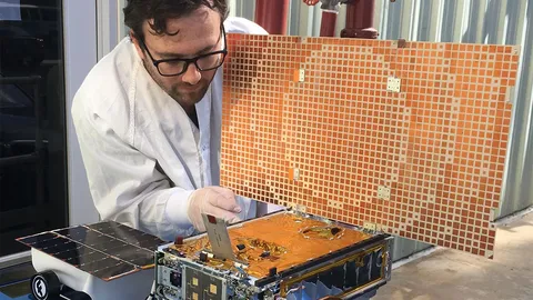 Photograph of a Marco Cubesat, showing the unfolded reflectarry antenna and one of the solar panels.