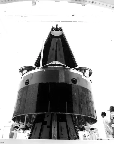 Encapsulation of the Pioneer Venus Multiprobe in its protective nose fairing is closely monitored by technicians in Hangar AO. The 2,000-pound…