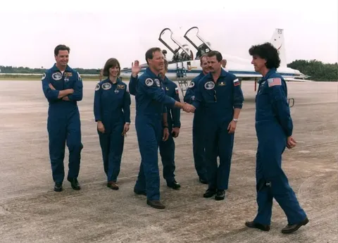 STS 71 crew greet each other after arrival