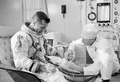 NASA astronaut Richard F. Gordon, Jr. suiting up prior to the Gemini 11 mission. NASA photo S66-50816 in public domain.