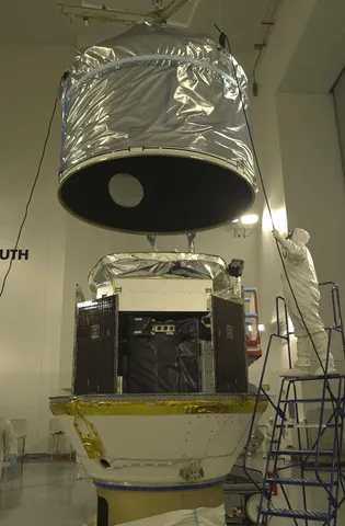 The upper part of the dual-payload attach fitting is lowered over CloudSat.