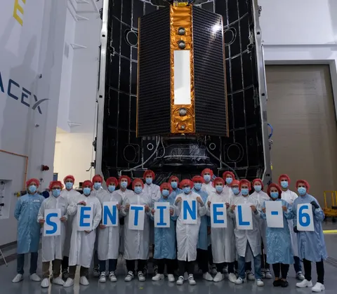 Last group picture for the launch campaign team before the Copernicus Sentinel-6 Michael Freilich satellite is sealed from view within the two…
