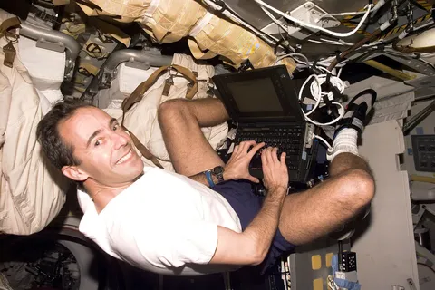 Astronaut Jean-Francois Clervoy, mission specialist representing the European Space Agency (ESA), uses a general purpose computer on Discovery's mid…