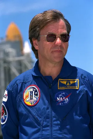 STS-85 Payload Specialist Bjarni V. Tryggvason stands ready for questions at a news briefing at Launch Pad 39A