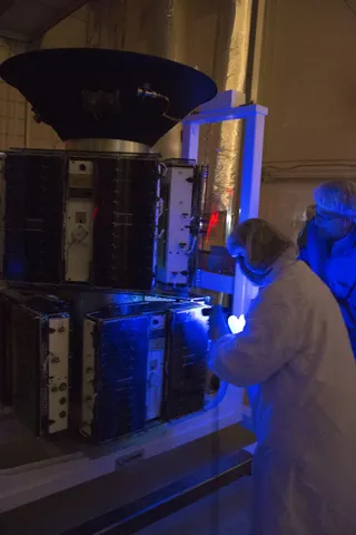 Blacklight test and thermal ring installation occurring on the CYGNSS spacecraft material, in preparation for its upcoming launch aboard the Pegasus…