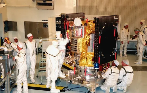 In the Payload Hazardous Servicing Facility, KSC workers place insulating blankets on Deep Space 1 to prepare it for launch.