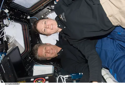 ISS 23 Tracy Caldwell Dyson and Piers Sellers pose for a photo in the Cupola module