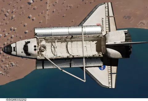 Space Shuttle Discovery Over Earth