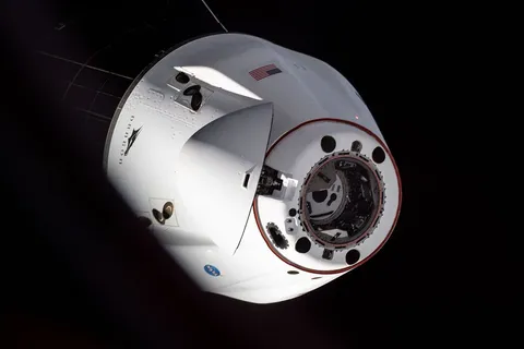 iss065e162289 (July 8, 2021) --- The SpaceX Cargo Dragon resupply ship is photographed departing the International Space Station after it undocked…