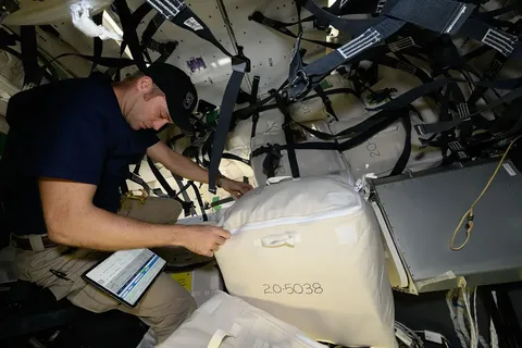 iss071e013805 (April 22, 2024) --- Expedition 71 Flight Engineer and NASA astronaut Matthew Dominick checks procedures on a computer tablet while…