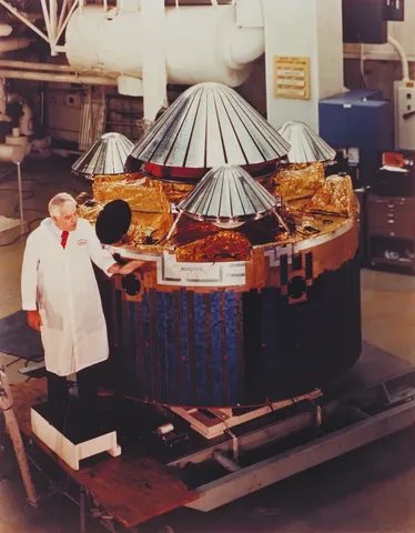 Charlie Hall inspects the Pioneer Venus multiprobe at Hughes Aircraft Co. in Dec. 1976