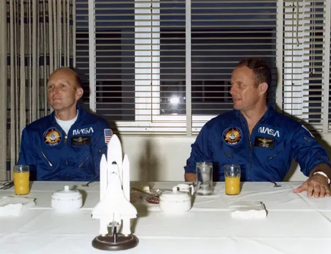 On launch day morning, STS-3 astronauts C. Gordon Fullerton, left, and Jack R. Lousma enjoy the traditional prelaunch breakfast in crew quarters at…