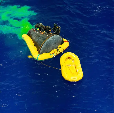 Gemini 4 rides the Atlantic swell with its flotation collar fitted after splashdown.