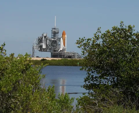 Reflected in the water of the Banana River at Kennedy Space Center, Fla., Space Shuttle Atlantis sits on Launch Pad 39A.