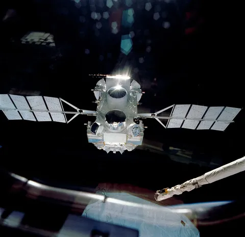 NASA's Compton Gamma Ray Observatory drifts away from the space shuttle Atlantis on April 7, 1991, following its deployment during the STS-37 mission.